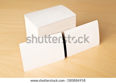 Stack of blank horizontal business cards propped up another with copy space for your design
