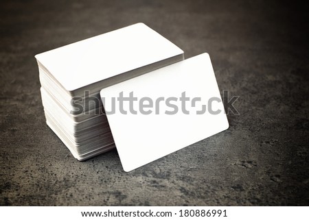 Stack of blank horizontal business cards propped up another with copy space for your design