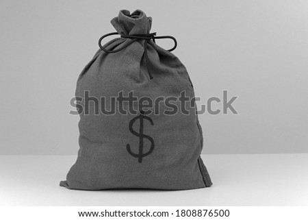 A Cloth Money Bag With A Dollar Symbol On The Front. Royalty-Free Stock Photo #1808876500