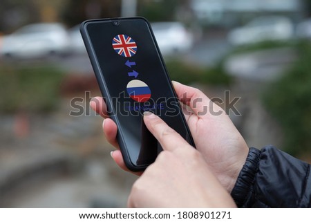 Woman hand holding smartphone in hand.Mobile application for translating foreign languages. 