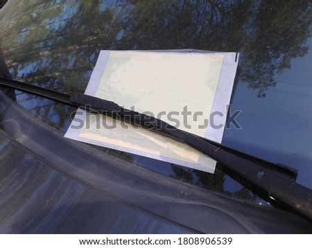 Ticket attached to the car windshield
