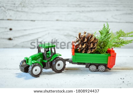 Christmas Tree on Tractor Toy on wooden close up