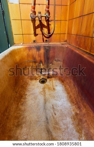 Rust stains in bathtub on wall and bath. High level Iron dissolved in a water. Ferrous Iron