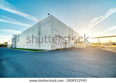Large industrial building, hangar. Early morning, dawn. Royalty-Free Stock Photo #1808952940
