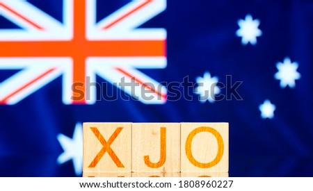 xjo. wood blocks with xjo (S & P / ASX 200) inscribed on the background of the flag of Australia