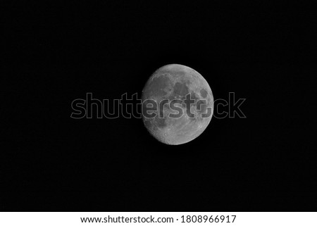 A beautiful waxing gibbous moon on a black background. 