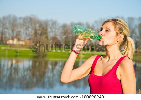 woman drinking water from bottle after fitness sport exercise 