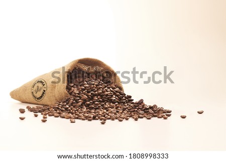 Coffee Beans in a sack bag isolated on white background.