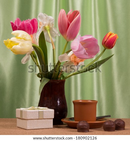 Bouquet of fresh spring flowers and a gift. Mother's Day concept.