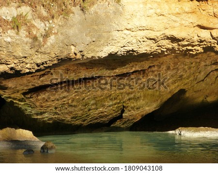 Mysterious sea cave on Adriatic sea. Sea grotto and calm waters. Seashore limestone cliff, Mediterranean coast. Dark cavern in coastal rocks.
	
