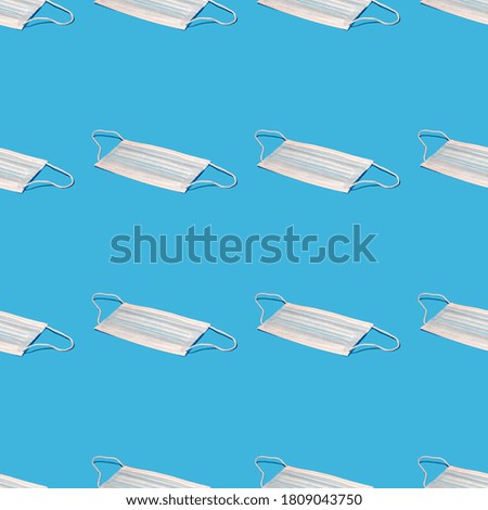 Seamless pattern with medical hygienic mask on blue background.