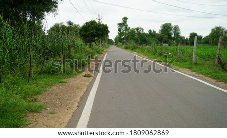 Amazing straight asphalt highway road view along with green field. Attractive white line mid of the road. Transportation technology. 