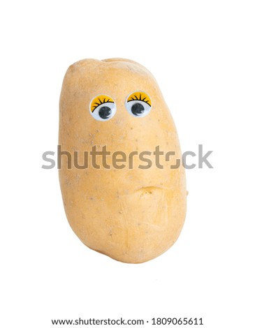 Potato  with eyes cut out on a white background