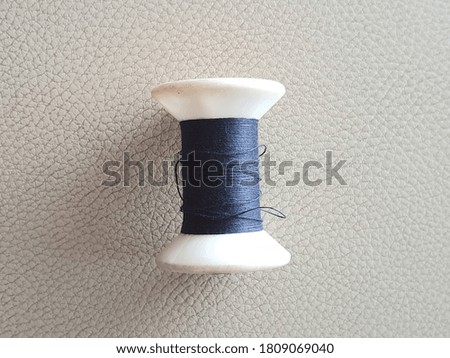 A blue thread on a brown background
