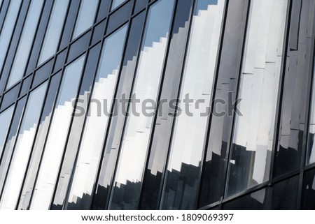  the modern facade of the building is made of glass and concrete with broken reflections. Concept-abstract background