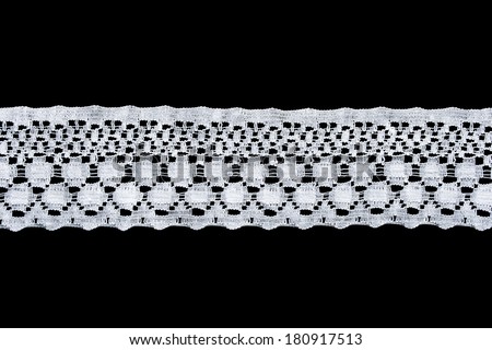 Strip of white lace isolated over black