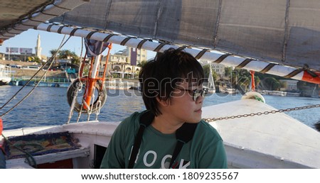 Aswan Egypt Asian tourist photograph at Nile river beautiful felucca histoical vacation trip