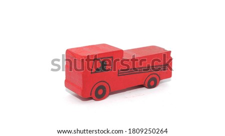Red wooden toy truck on isolated white background