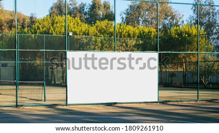 empty advertising white banner with mockup on iron fence on sport playground front view