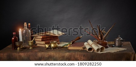 The workplace of a scientist or writer from past centuries. Vintage items, books and manuscripts on a dark background. Space for your text. Royalty-Free Stock Photo #1809282250