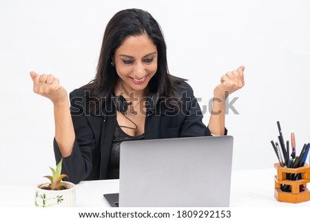 Portrait of professional Indian businesswoman at the table working  from her computer, Freelancer, work from home, Smiling corporate lady