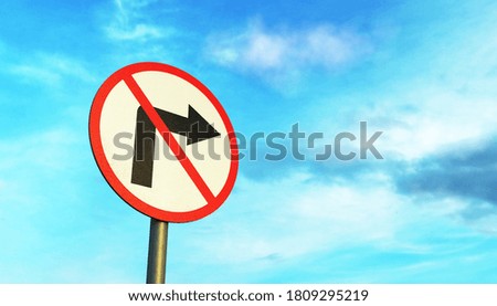 No Turning road sign on a metal pole against a blue sky