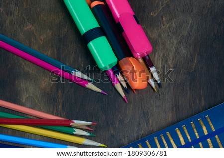 Multi-colored pencils on a wooden table