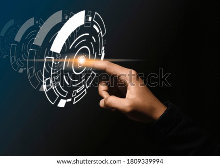 Businessman presses finger on the center and shows a concept of technology hologram.