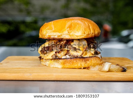 Smash burger on a cutting board looking delicious 