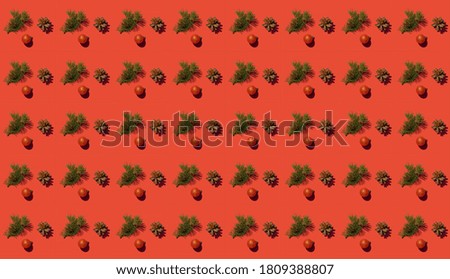 Creative pattern with a fir branch and a cone on a red background. The Concept Of Christmas