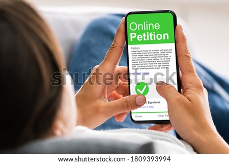 Holding Mobile Phone To Sign Petition. Online Report