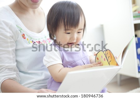 A family reading a picture book together,