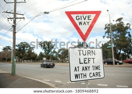 Road sign Turn left at any time with care. Australia, Melbourne. Warning sign.  Give way.