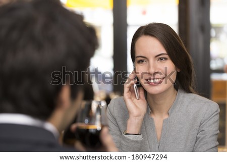 Young couple in restaurant, woman is on the phone