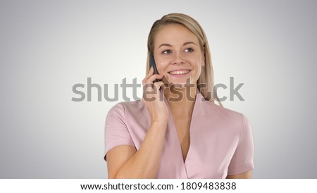 Portrait of smiling beautiful young woman close up with mobile phone on gradient background.
