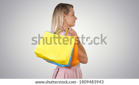 Let's start the sale shopping Woman in pink walking with shopping bags on gradient background.
