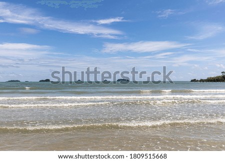 Seascape shot showing blue cloudy sky over a tropical sea on sunny day