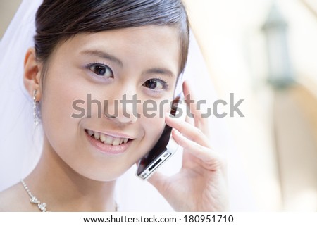 Japanese bride talking on a smart phone