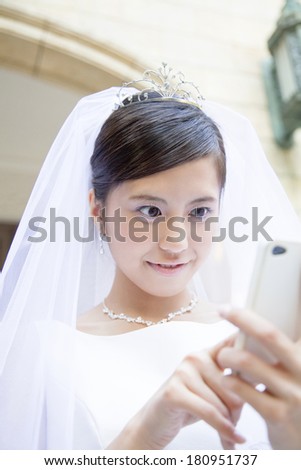 Japanese bride using a smart phone