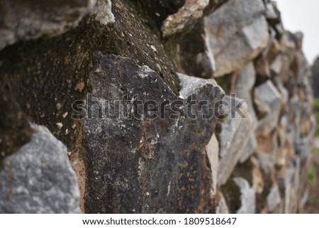 Old grey color stone wall picture.