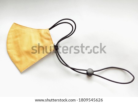 The half folded two-layer cloth mask, cotton and muslin with ear and neck strap can be adjusted to fit when wearing. The washable and comfortable cloth mask for wearing when out in public, new normal.
