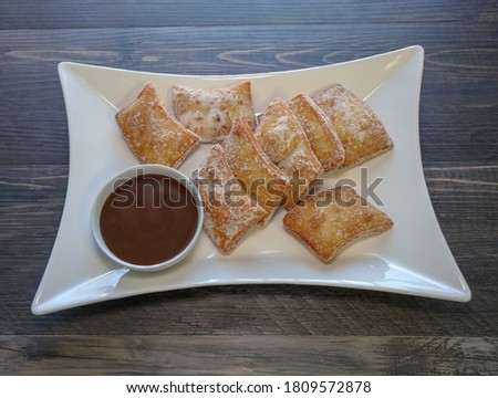 Zeppoli, Italian doughnuts with powdered sugar and chocolate dipping sauce.