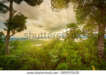 Aerial View of ranong hill for seascape with sunset rays through the cloud and rain forest of thailand
