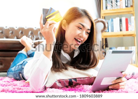 Picture showing pretty woman shopping online with credit card, using digital tablet to shop online