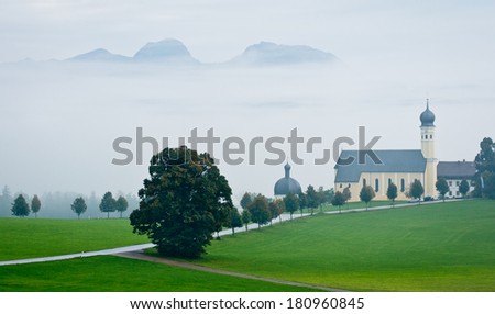 View of Austrian landscape with church in bad weather