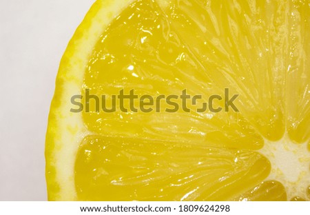 Close-up slices of juicy fresh lemon on a white background, natural texture
