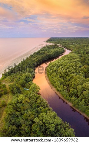 Aerial view of small village Kg. Penat in Mukah Sarawak Malaysia. Top view of river from flying drone.