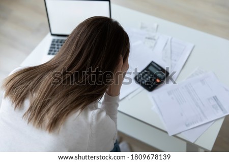 Top back rear head shot view stressed millennial woman feeling confused of banking debt, termination letter while managing home expenditures alone indoors, financial problems bankruptcy concept. Royalty-Free Stock Photo #1809678139