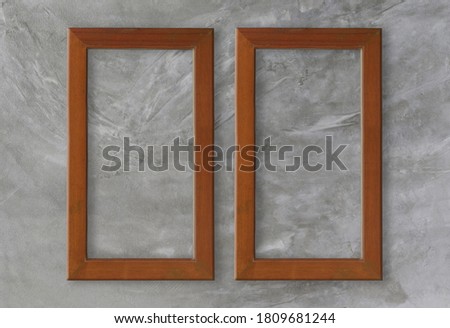Empty wooden frame on gray cement wall background for design in your work.