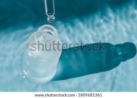Hyaluronic acid dropper and bottle in water.
